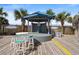 Outdoor entertainment space featuring a stage, bar-height seating, and tropical palm tree landscaping at 2711 S Ocean Blvd. # 621, North Myrtle Beach, SC 29582