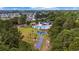 Aerial view of the community pool, playground, bocce court, and surrounding homes and trees at 293 Hillsborough Dr., Conway, SC 29526