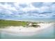 Sweeping view from above showcasing the beach, dunes, and ocean shoreline under cloudy sky at 293 Hillsborough Dr., Conway, SC 29526