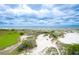Breathtaking aerial view of the beach, dunes, and ocean under a cloudy sky at 293 Hillsborough Dr., Conway, SC 29526