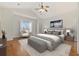 Bright bedroom with vaulted ceiling, ceiling fan, hardwood floors, and an upholstered bench at the foot of the bed at 293 Hillsborough Dr., Conway, SC 29526