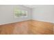 A bedroom with hardwood flooring, white walls, a ceiling fan and a large window at 293 Hillsborough Dr., Conway, SC 29526
