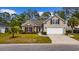 Charming home with well-manicured lawn, flowering shrubs, and a two-car garage at 293 Hillsborough Dr., Conway, SC 29526
