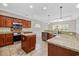Well-appointed kitchen boasts granite countertops, stainless steel appliances, and custom cabinetry at 293 Hillsborough Dr., Conway, SC 29526