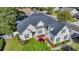 Well-maintained home with lush landscaping, white siding, black shutters, and a dark grey roof at 3300 Prioloe Dr., Myrtle Beach, SC 29588