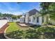 Charming backyard with patio, manicured lawn, white fence, and playhouse, perfect for outdoor enjoyment at 3300 Prioloe Dr., Myrtle Beach, SC 29588