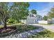 Charming home exterior with a spacious driveway, lush lawn, and mature trees at 3300 Prioloe Dr., Myrtle Beach, SC 29588