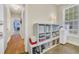 Hallway featuring wooden floor, shelf with storage boxes, and natural light at 3300 Prioloe Dr., Myrtle Beach, SC 29588