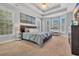 Comfortable main bedroom with a tray ceiling, several windows, and calming paint scheme at 3300 Prioloe Dr., Myrtle Beach, SC 29588