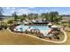 Aerial view of community pool with lounge chairs, umbrellas and nearby clubhouse at 351 Logan St., Little River, SC 29566