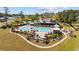 Aerial view of community pool with lounge chairs, umbrellas and nearby clubhouse at 351 Logan St., Little River, SC 29566