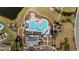 Overhead shot of community pool with lounge chairs, umbrellas, clubhouse, and playground at 351 Logan St., Little River, SC 29566