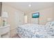 Relaxing bedroom featuring a TV, white dresser and nightstand, with a matching white closet at 351 Logan St., Little River, SC 29566