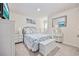 Comfortable bedroom with coastal decor, light carpet, matching nightstands and lamps, with a white storage bench at 351 Logan St., Little River, SC 29566