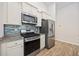Kitchen features stainless steel appliances, granite countertops, and blue glass backsplash at 351 Logan St., Little River, SC 29566