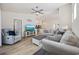 Open-concept living room with hardwood floors, modern furniture, and an open view into the kitchen at 351 Logan St., Little River, SC 29566