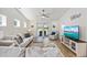 Bright living room with a ceiling fan, modern furniture, and a sliding glass door to the outside at 351 Logan St., Little River, SC 29566