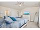 Bright main bedroom with a ceiling fan, white furniture, and a view into the main bathroom at 351 Logan St., Little River, SC 29566