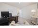 Cozy office space with carpeted floors, a desk, and a peek into the kitchen area at 351 Logan St., Little River, SC 29566