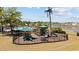 Community playground featuring modern equipment and a picnic table, all within a secure fenced area at 351 Logan St., Little River, SC 29566