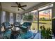 Inviting screened porch with comfortable seating, ceiling fan, and views of the lush green lawn at 351 Logan St., Little River, SC 29566