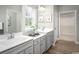 Elegant bathroom with dual sinks, gray cabinets, and a well-lit mirror at 439 Myrtle Meadows Dr, Conway, SC 29526