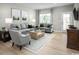 Bright living room with two gray sofas, a gray accent chair, and a large window at 439 Myrtle Meadows Dr, Conway, SC 29526