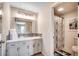 Bathroom featuring a double vanity, mirror, tiled backsplash, and shower with a curtain at 4504 S Ocean Blvd. # A, North Myrtle Beach, SC 29582