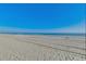 Wide sandy beach stretching to the horizon under a bright blue sky, ready for activities at 4504 S Ocean Blvd. # A, North Myrtle Beach, SC 29582