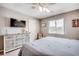 Bedroom with neutral walls, a flat-screen television, light dresser, and nautical decor at 4504 S Ocean Blvd. # A, North Myrtle Beach, SC 29582