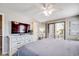 Bright bedroom with a TV, desk, balcony access, and neutral decor at 4504 S Ocean Blvd. # A, North Myrtle Beach, SC 29582