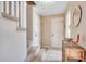 Welcoming entryway with stairs, tiled flooring and a charming decorative table at 4504 S Ocean Blvd. # A, North Myrtle Beach, SC 29582