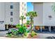Building exterior showcasing palm trees, well-kept landscaping, covered parking, and ocean views at 4504 S Ocean Blvd. # A, North Myrtle Beach, SC 29582