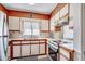 Bright kitchen with light cabinets, wood trim, and a window providing natural light at 4504 S Ocean Blvd. # A, North Myrtle Beach, SC 29582