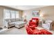 Cozy living room with nautical decor, a gray sofa and a bright red armchair at 4504 S Ocean Blvd. # A, North Myrtle Beach, SC 29582