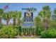 Welcome sign for North Myrtle Beach with lush landscaping and a patriotic American flag at 4504 S Ocean Blvd. # A, North Myrtle Beach, SC 29582