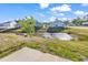 Backyard shows a small waterway, lawn, and surrounding houses in the neighborhood at 500 Dundalk Dr., Conway, SC 29526