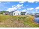 Backyard view showing the home's rear exterior, grassy area, and a waterway at 500 Dundalk Dr., Conway, SC 29526