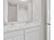 Well-lit bathroom featuring double sinks, a large mirror, and white cabinetry at 500 Dundalk Dr., Conway, SC 29526