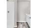 Bright bathroom featuring a white shower, marble countertops, and gray plank flooring at 500 Dundalk Dr., Conway, SC 29526