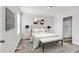 Bedroom with a bed, two side tables, an ensuite bath, and an accent wall with art at 500 Dundalk Dr., Conway, SC 29526