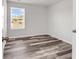 Bedroom with wood-look flooring, window with blinds, and light gray walls at 500 Dundalk Dr., Conway, SC 29526
