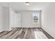 Spacious bedroom with wood-look flooring and a bright window overlooking the yard at 500 Dundalk Dr., Conway, SC 29526