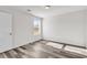 Bedroom featuring wood-look floors, neutral paint, a window, and a white door at 500 Dundalk Dr., Conway, SC 29526