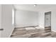 Bedroom with neutral colored walls, wood style floors, large window, and an attached bathroom at 500 Dundalk Dr., Conway, SC 29526