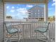 Inviting balcony with chairs and a view of the building at 5000 N Ocean Blvd. # B-1, North Myrtle Beach, SC 29582