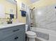 Stylish bathroom featuring a modern vanity, marble tiled shower, and beach-themed decorations at 5000 N Ocean Blvd. # B-1, North Myrtle Beach, SC 29582