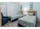 Charming bedroom with two twin beds, blue and white bedding, and nautical wall art at 5000 N Ocean Blvd. # B-1, North Myrtle Beach, SC 29582