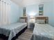Inviting bedroom with twin beds, coastal decor, and soft lighting at 5000 N Ocean Blvd. # B-1, North Myrtle Beach, SC 29582