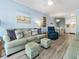 Bright living room with comfortable seating, modern vinyl flooring, and a view into the kitchen and dining areas at 5000 N Ocean Blvd. # B-1, North Myrtle Beach, SC 29582